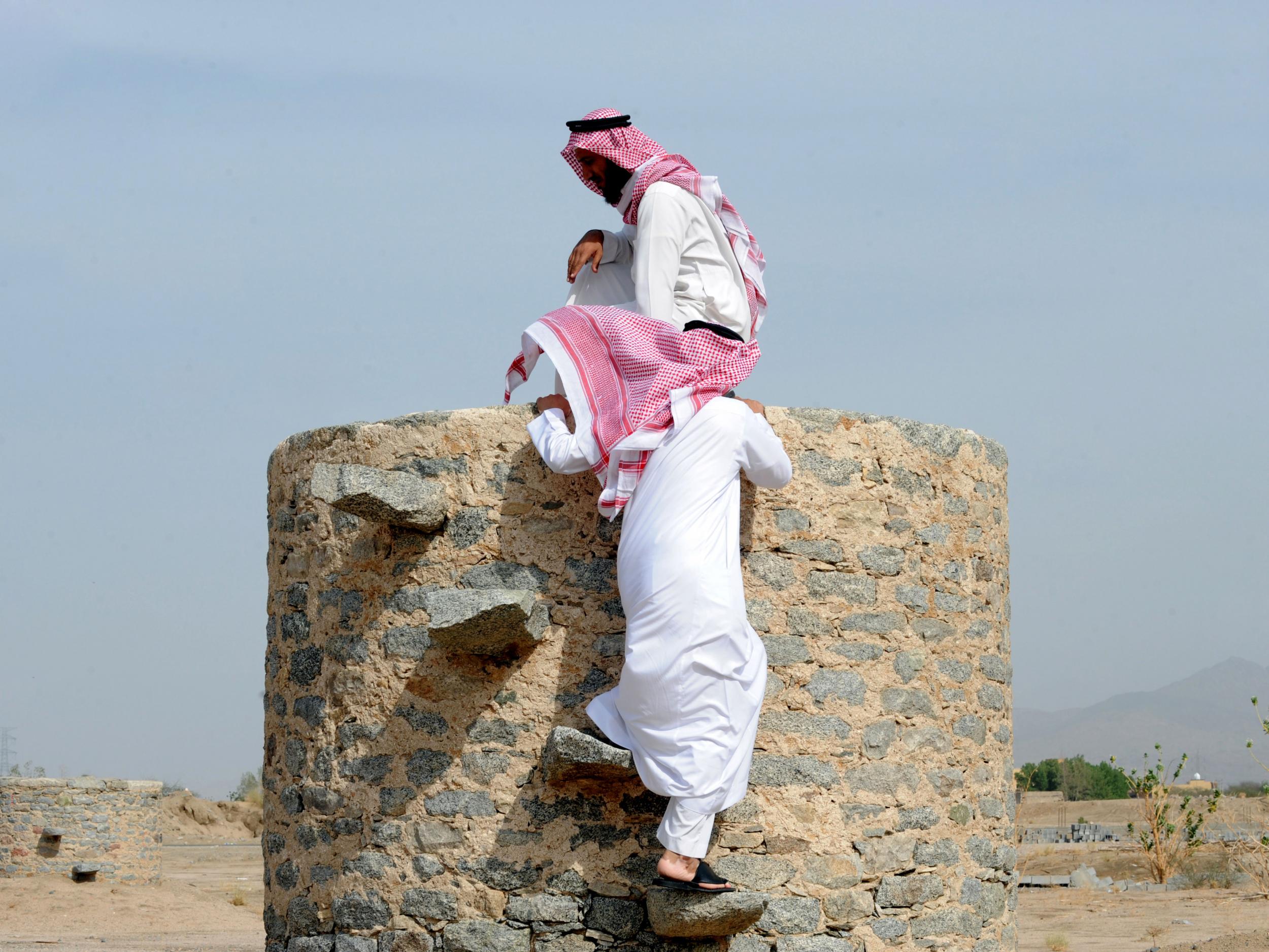 Saudi men visit the Ain Zubaida archaeological site in the Muslim holy city of Mecca on October 22, 2012. The wells of Ain Zubaida served Muslim pilgrims for hundreds of years as an essential water source in the desert region.