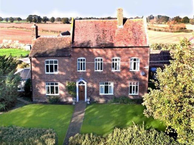 This seven bedroom detached house in Nobold, Shrewsbury is a former farmhouse dating back to the mid-18th century. As well as a guest suite, the property has brick outbuildings and an outdoor swimming pool