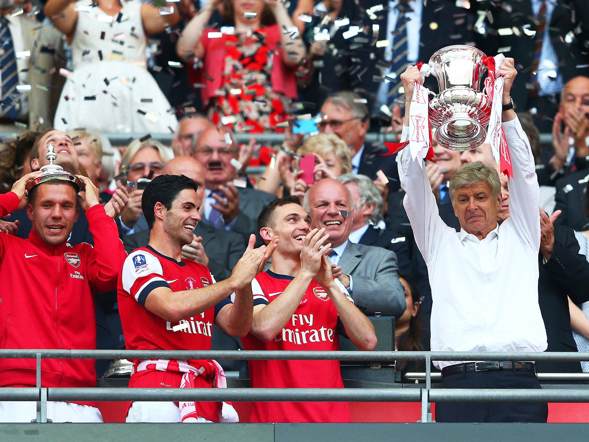 Arsene Wenger lifts the FA Cup in 2014 after Arsenal's 3-2 win over Hull