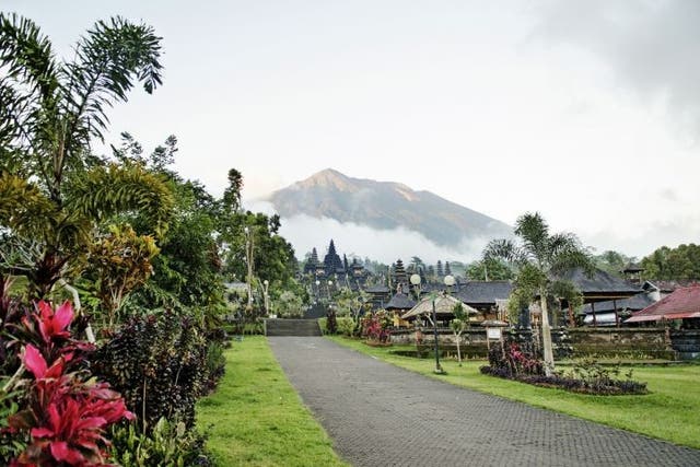 Mount Agung looms above a temple