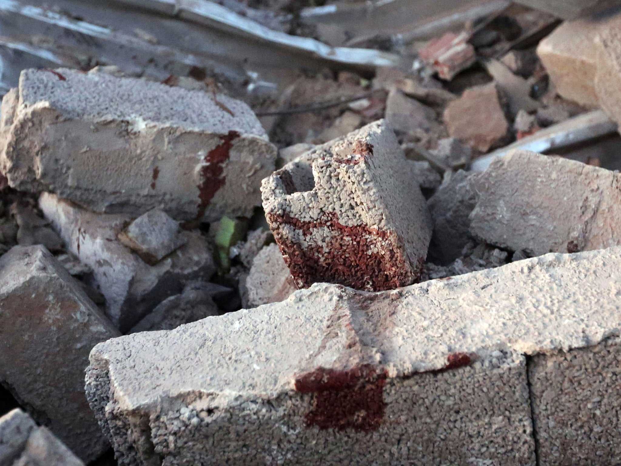 Bloodstains are seen on debris at the site of a jihadist training camp, targeted in a US air strike, near the Libyan city of Sabratha on February 19, 2016.