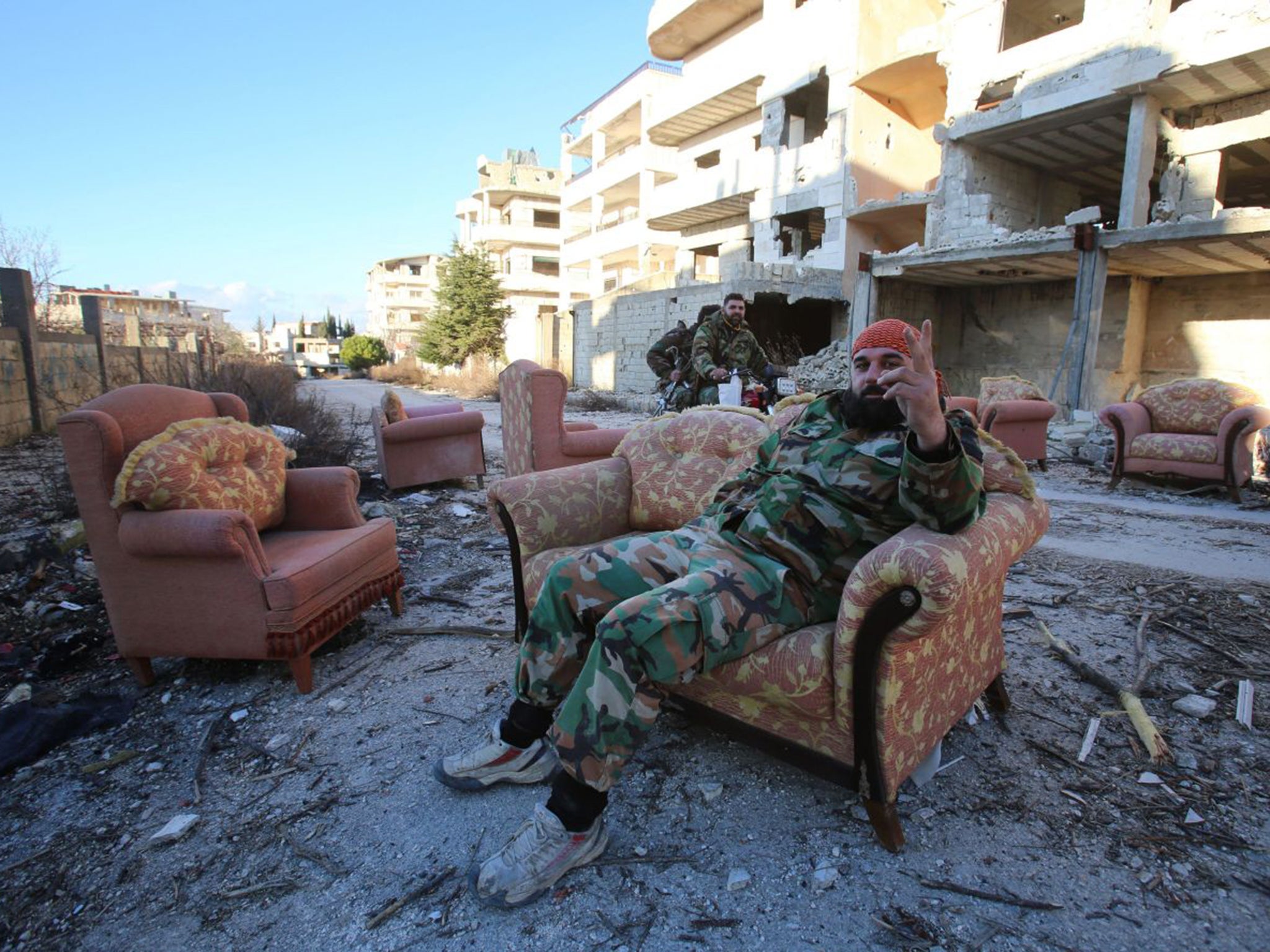 A government soldier relaxes after the recapture of Salma from IS