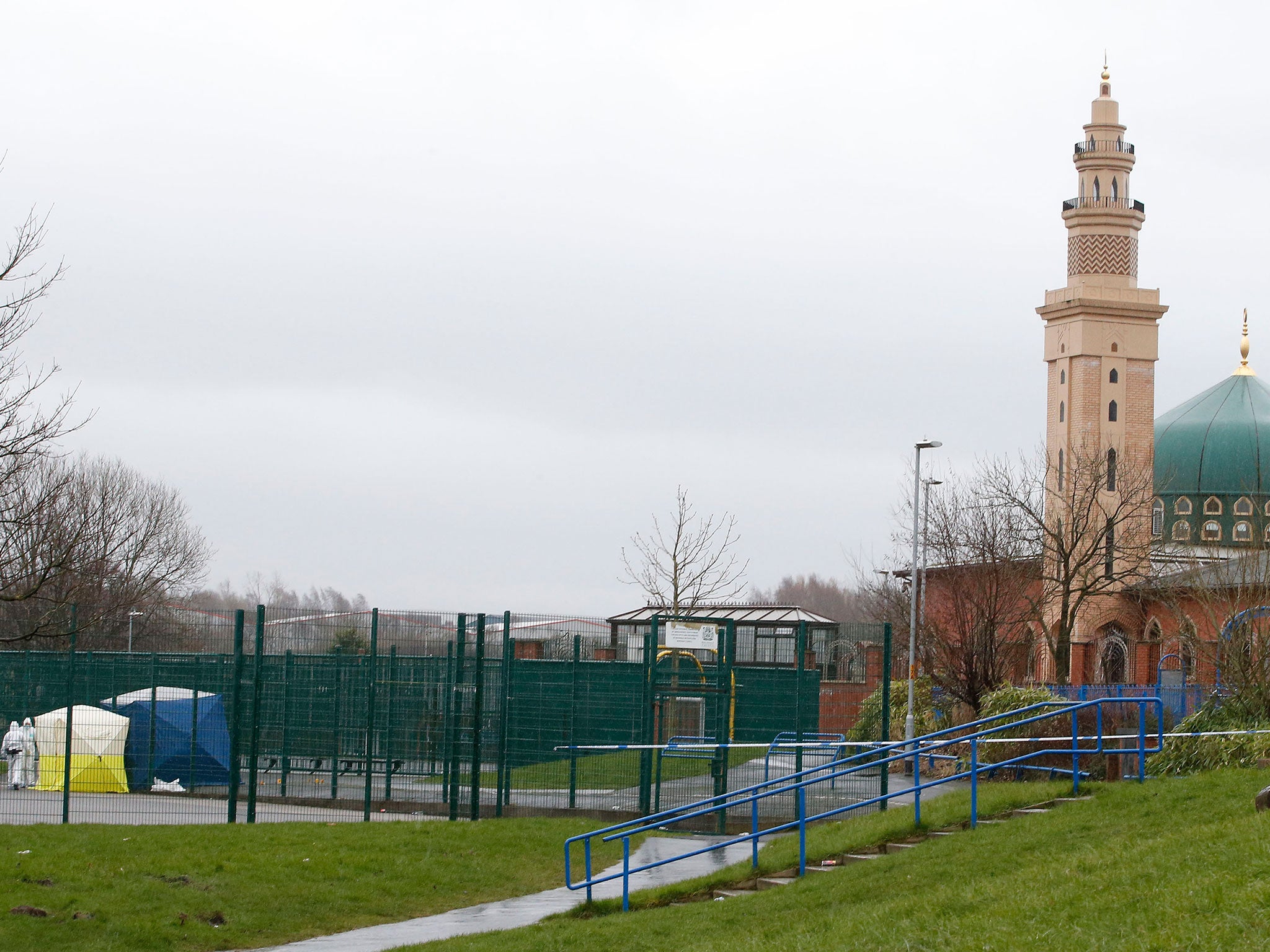 Crime scene investigators at a childrens play area (left) in Rochdale where an imam of a mosque has died after being found with serious head injuries while on his way home from evening prayers.