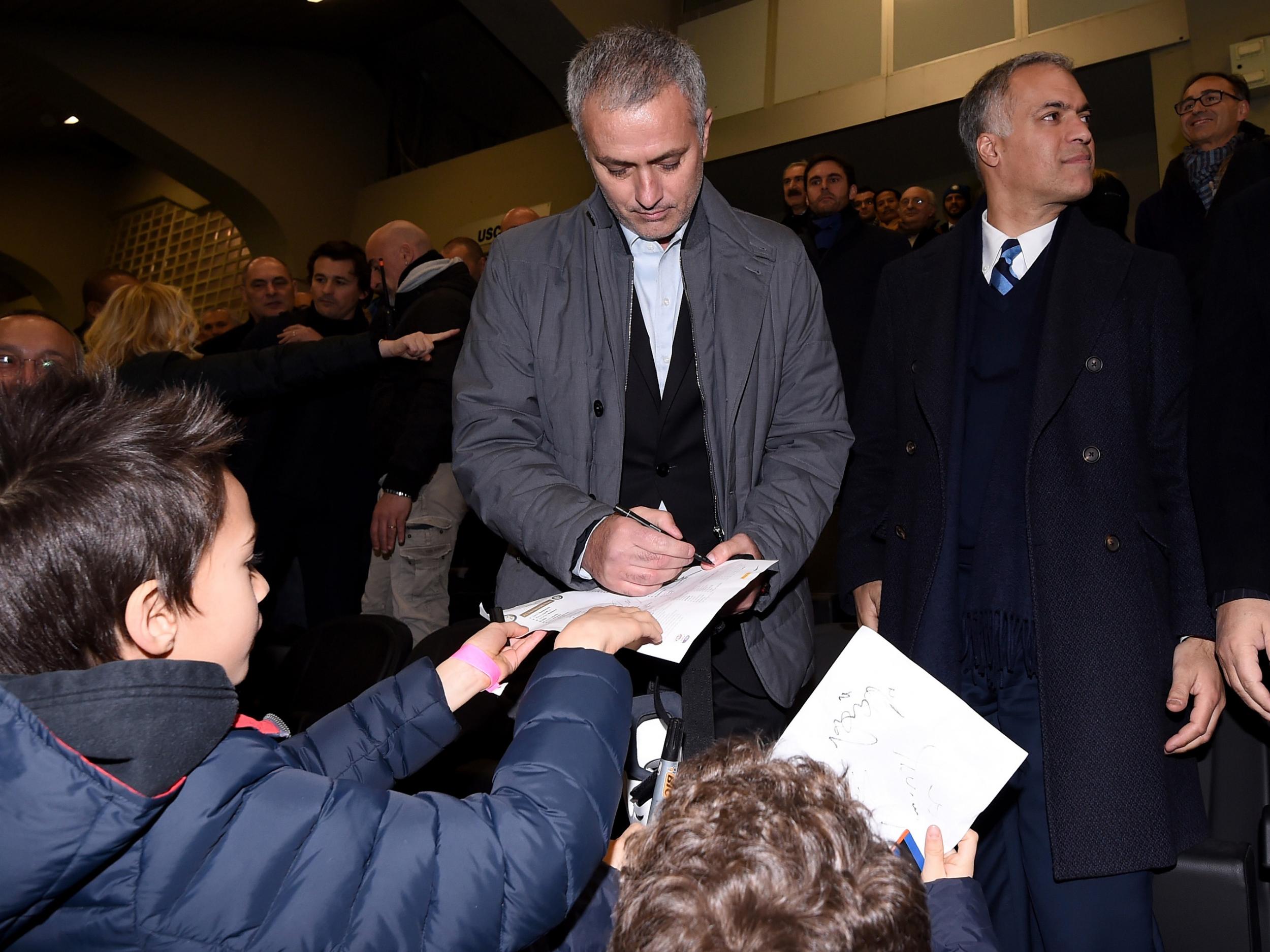 Jose Mourinho signs autographs for Inter Milan supporters while visiting his former club