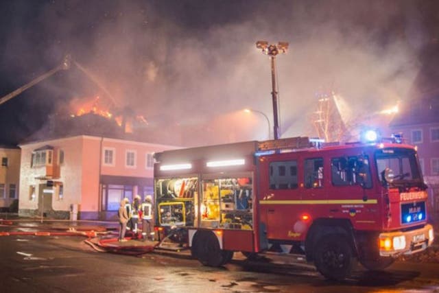 Firefighters tackle a fire in a planned refugee home in Bautzen, Germany, 21 February, 2016