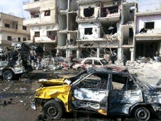 At least 57 dead in twin Isis-claimed attacks in Homs, Syria