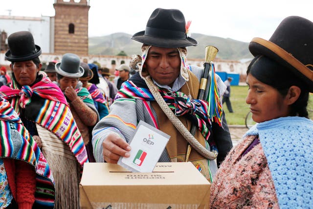An Aymara Indian casts his ballot at a voting station in Jesus de Machaca, Bolivia