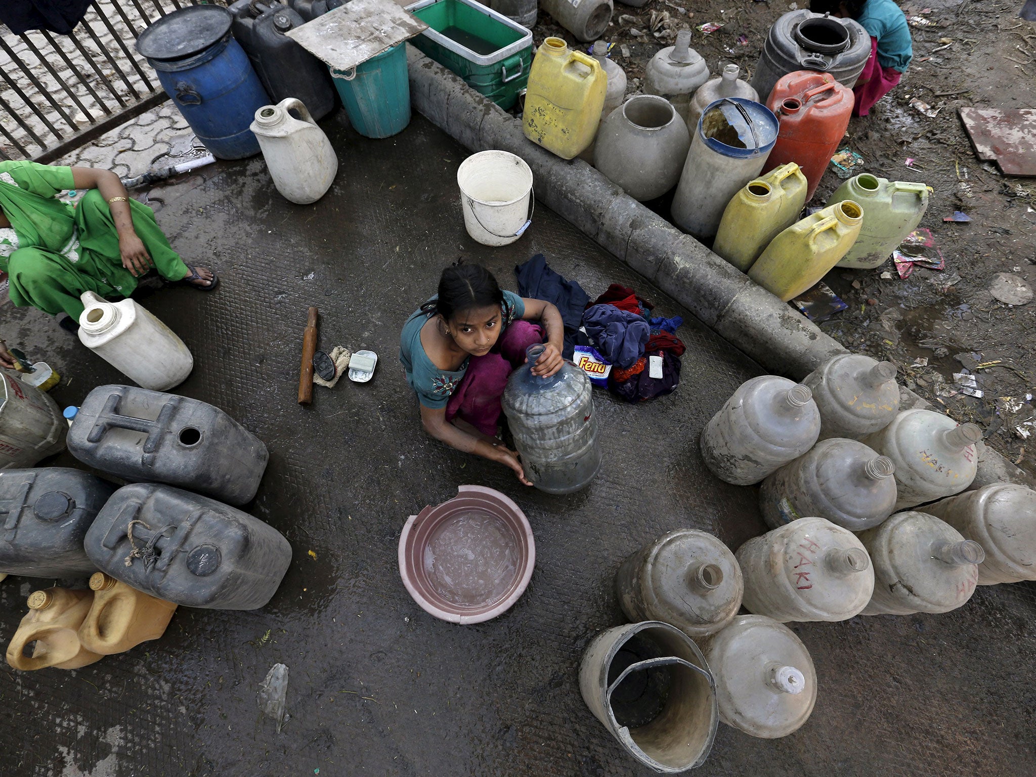 A girl waiting to fill water containers from a municipal tap in Delhi, where the protests have created a shortage