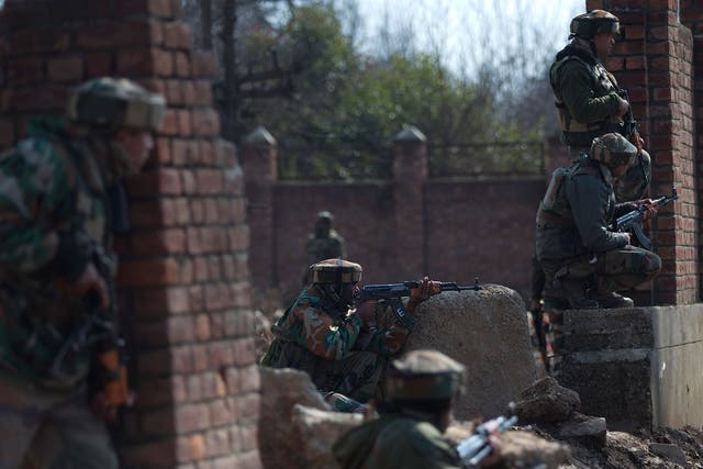 Indian army soldiers take position against a handful of rebels holed up in a building in the Indian portion of Kashmir. The rebels have exchanged fire with government forces for the two days straight, leaving some killed and many injured