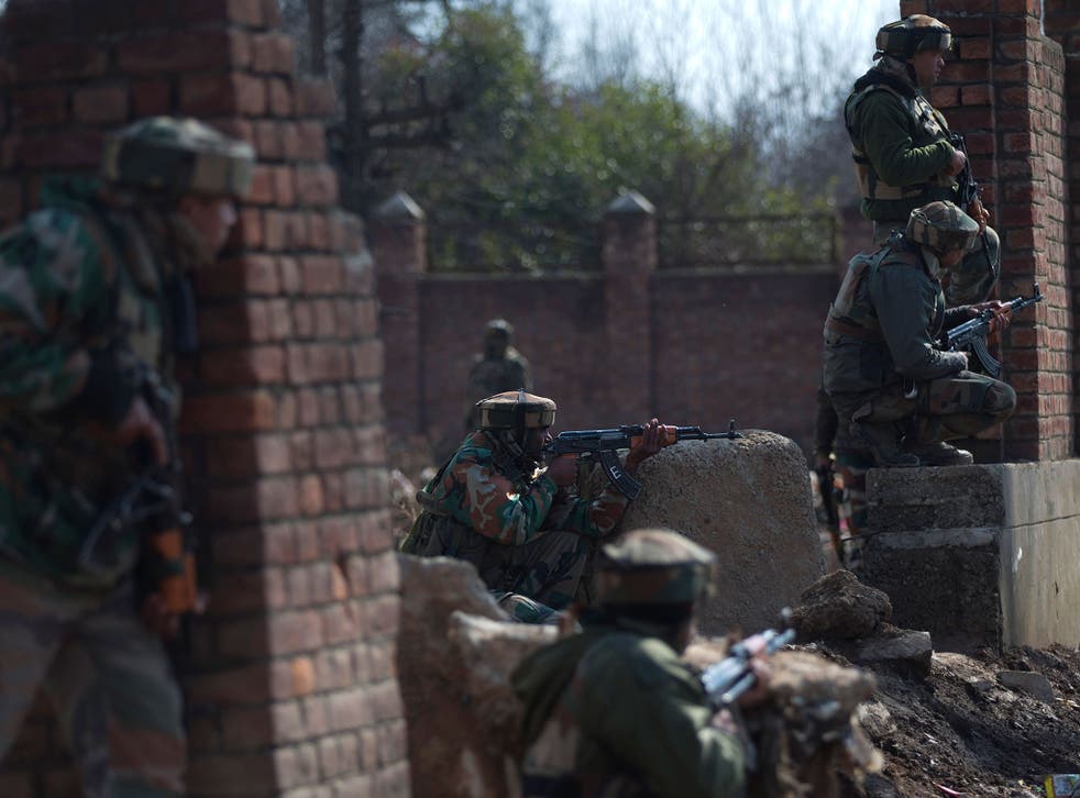 Indian army soldiers take position against a handful of rebels holed up in a building in the Indian portion of Kashmir. The rebels have exchanged fire with government forces for the two days straight, leaving some killed and many injured
