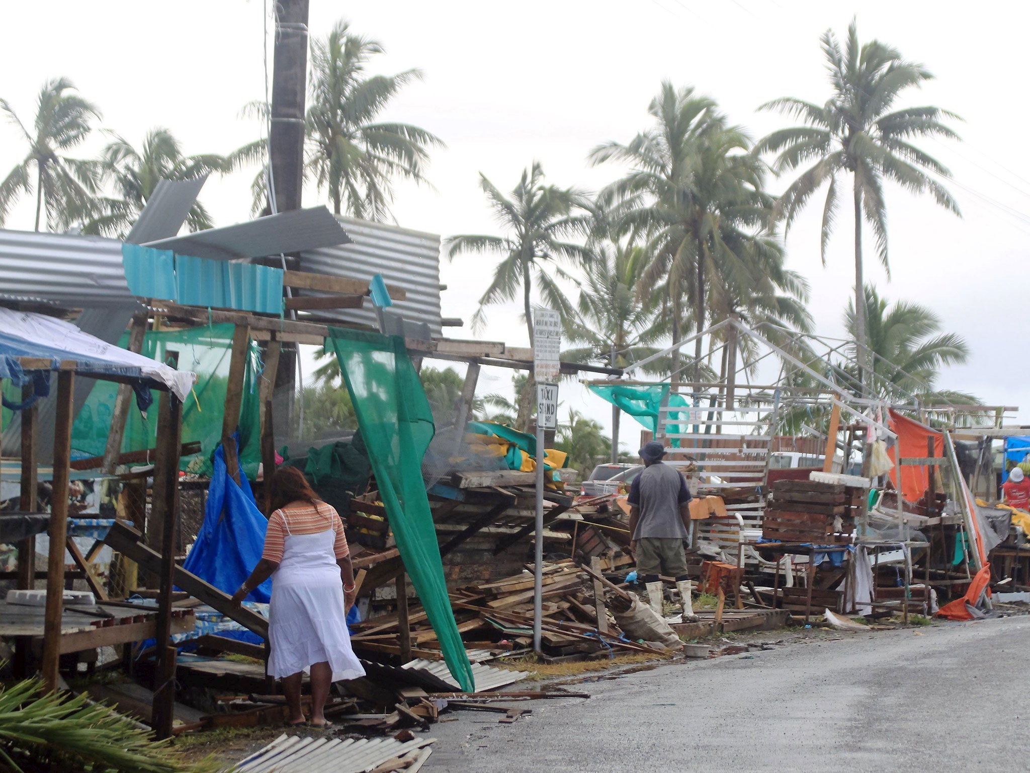 Workers at a fruit and vegetable market begin the clear up