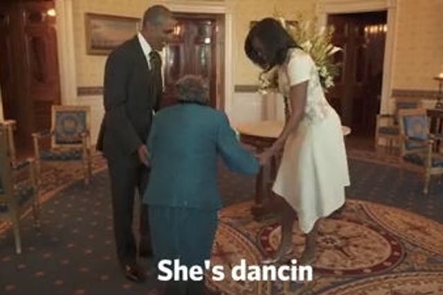 Obamas dancing with 106-year-old woman