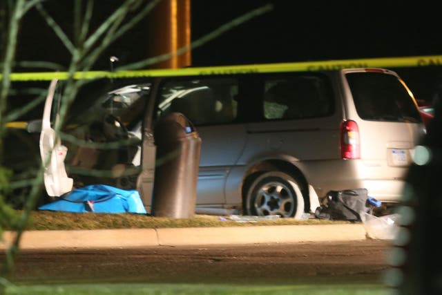 Police investigate the scene of one of the shooting scenes in Kalamazoo