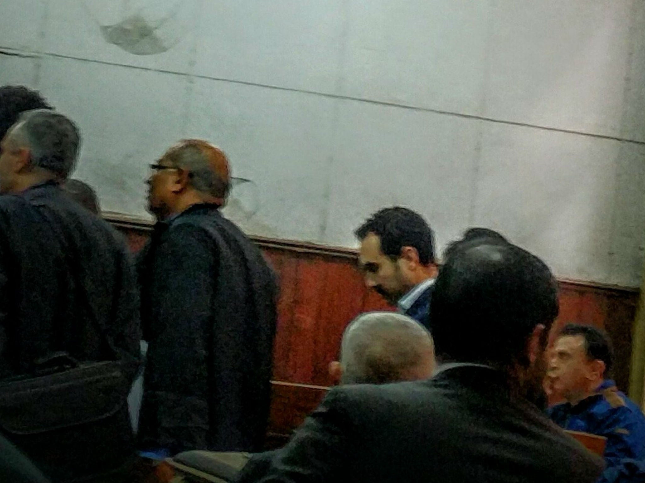 Naji (centre with head bowed) attends the court hearing in Cairo