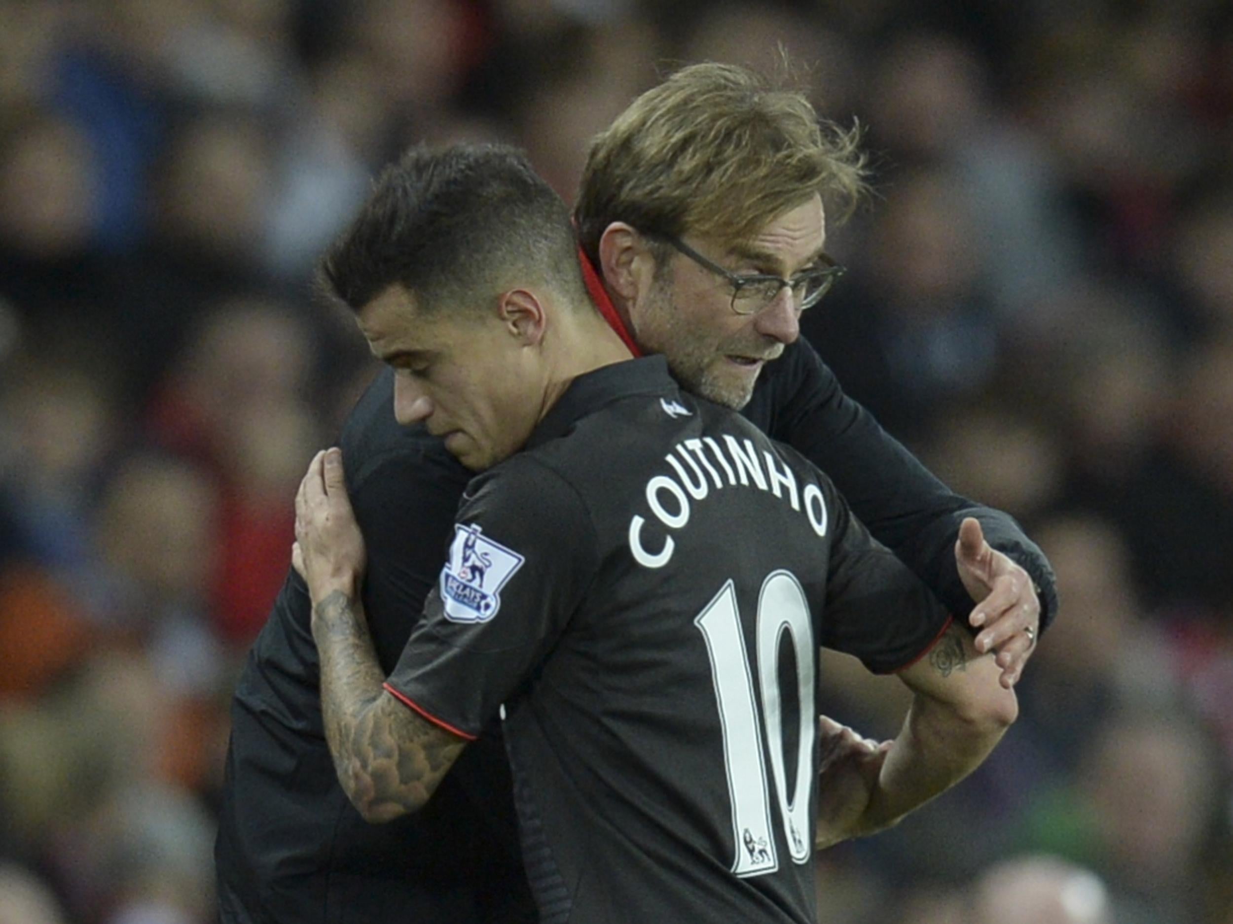 Jurgen Klopp and Philippe Coutinho embrace on the sidelines