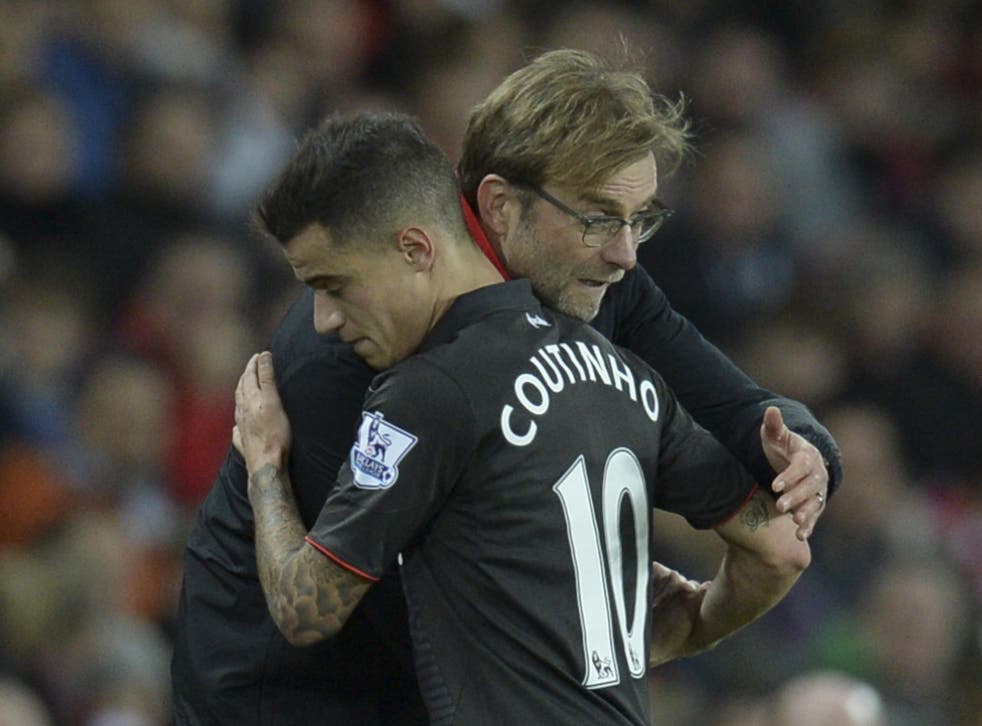 Jurgen Klopp and Philippe Coutinho embrace on the sidelines