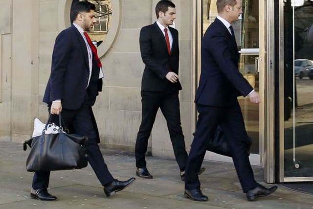 Footballer Adam Johnson, centre, arrives at Bradford Crown Court with his legal team to give evidence for the first time in his trial