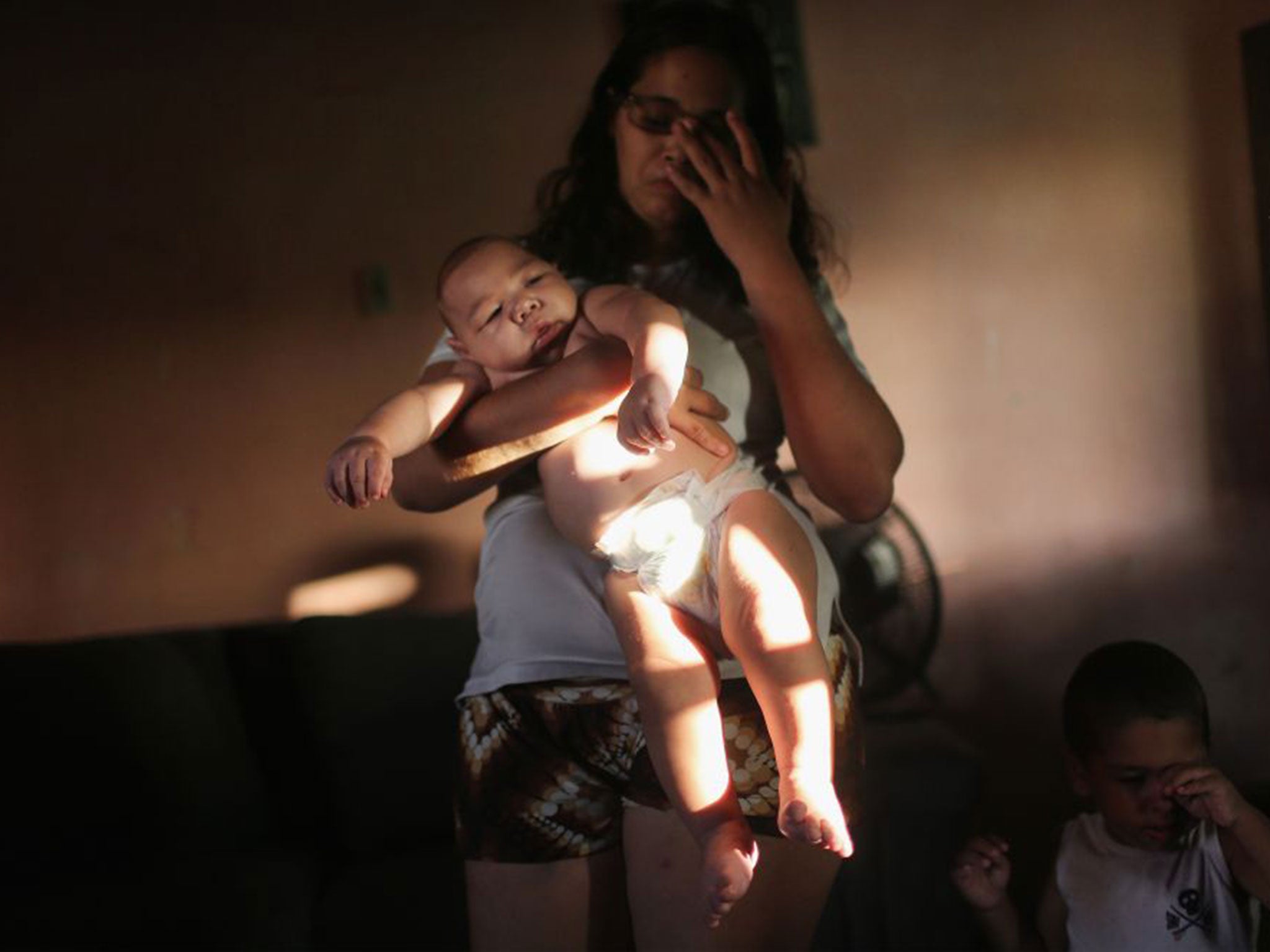 Mylene Helena Ferreira holds her five-month-old son David Henrique, who has microcephaly, in Recife, Brazil. The condition is thought to be caused by Zika in pregnant women