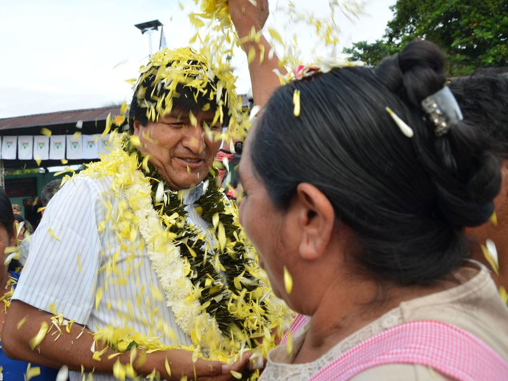 A coca farmer welcomes Evo Morales as he arrives at a polling station in Chapare on Sunday