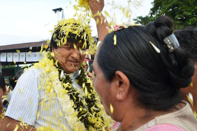 A coca farmer welcomes Evo Morales as he arrives at a polling station in Chapare on Sunday