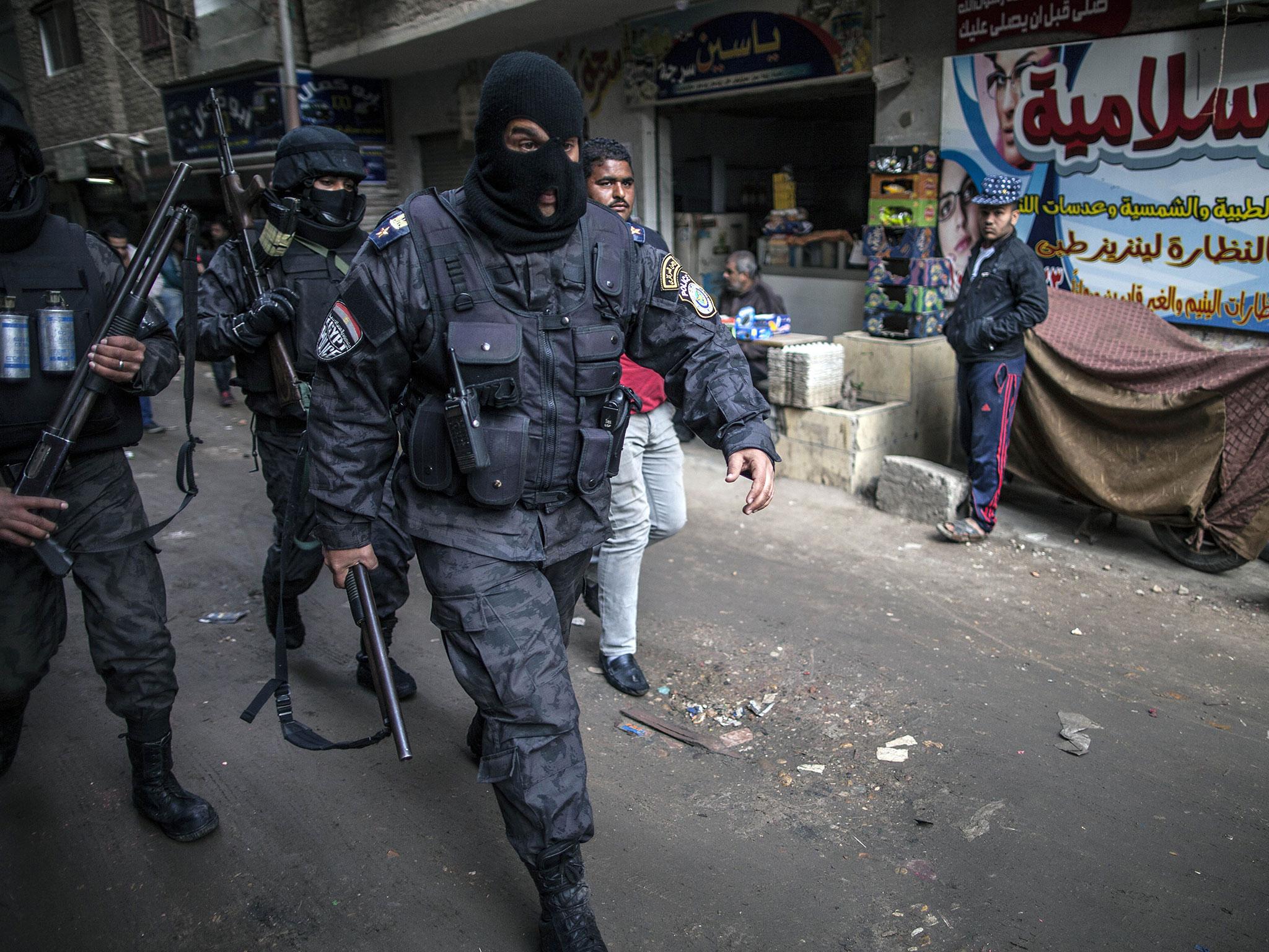 Members of the Egyptian police special forces patrol streets in al-Haram neighbourhood in the southern Cairo Giza district on 25 January, 2016, in order to head off potential protests against President Abdel Fattah al-Sisi's government
