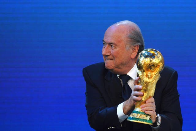 Sepp Blatter holds the World Cup trophy