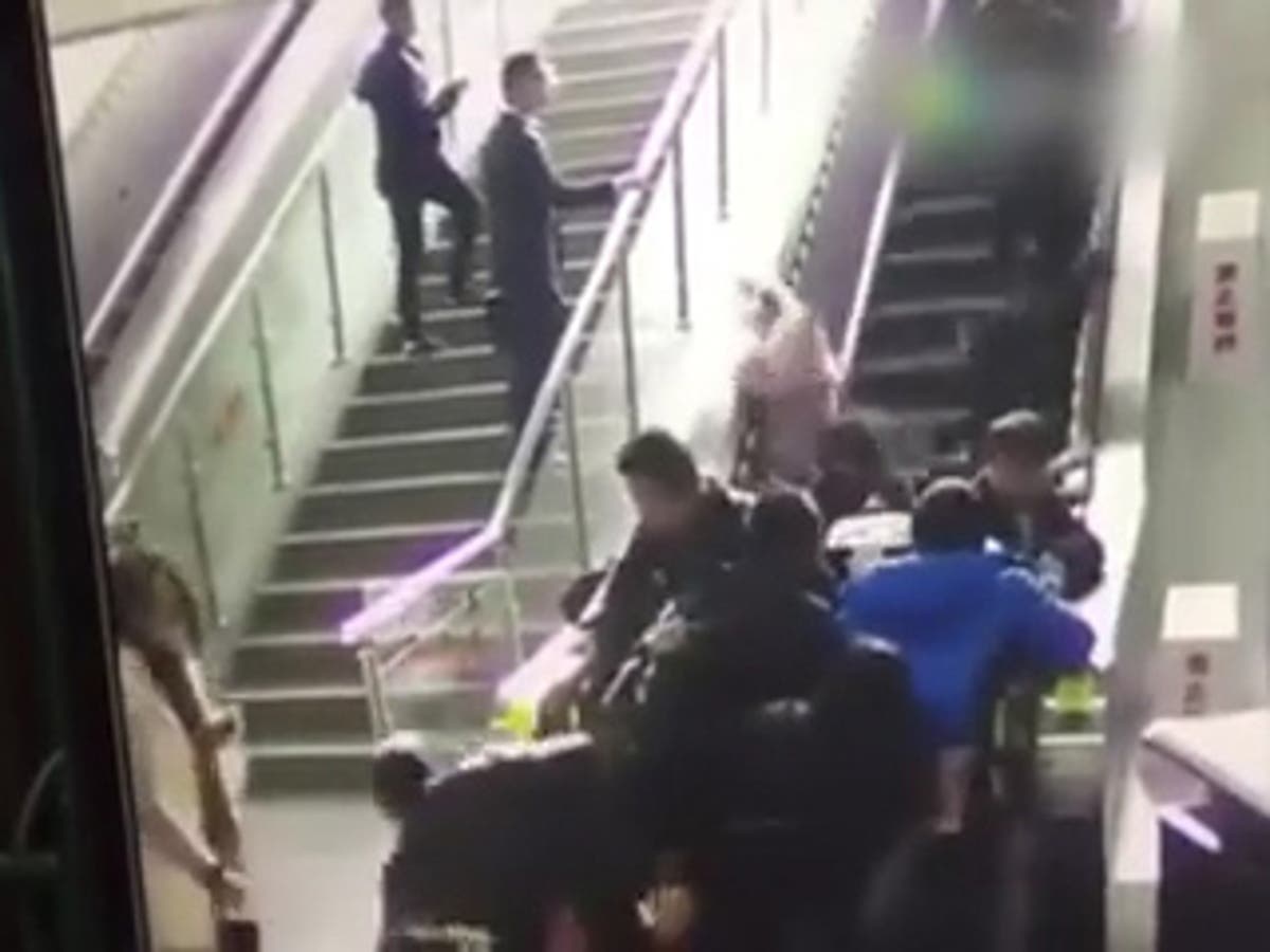 Escalator in China unexpectedly switches direction throwing passengers ...