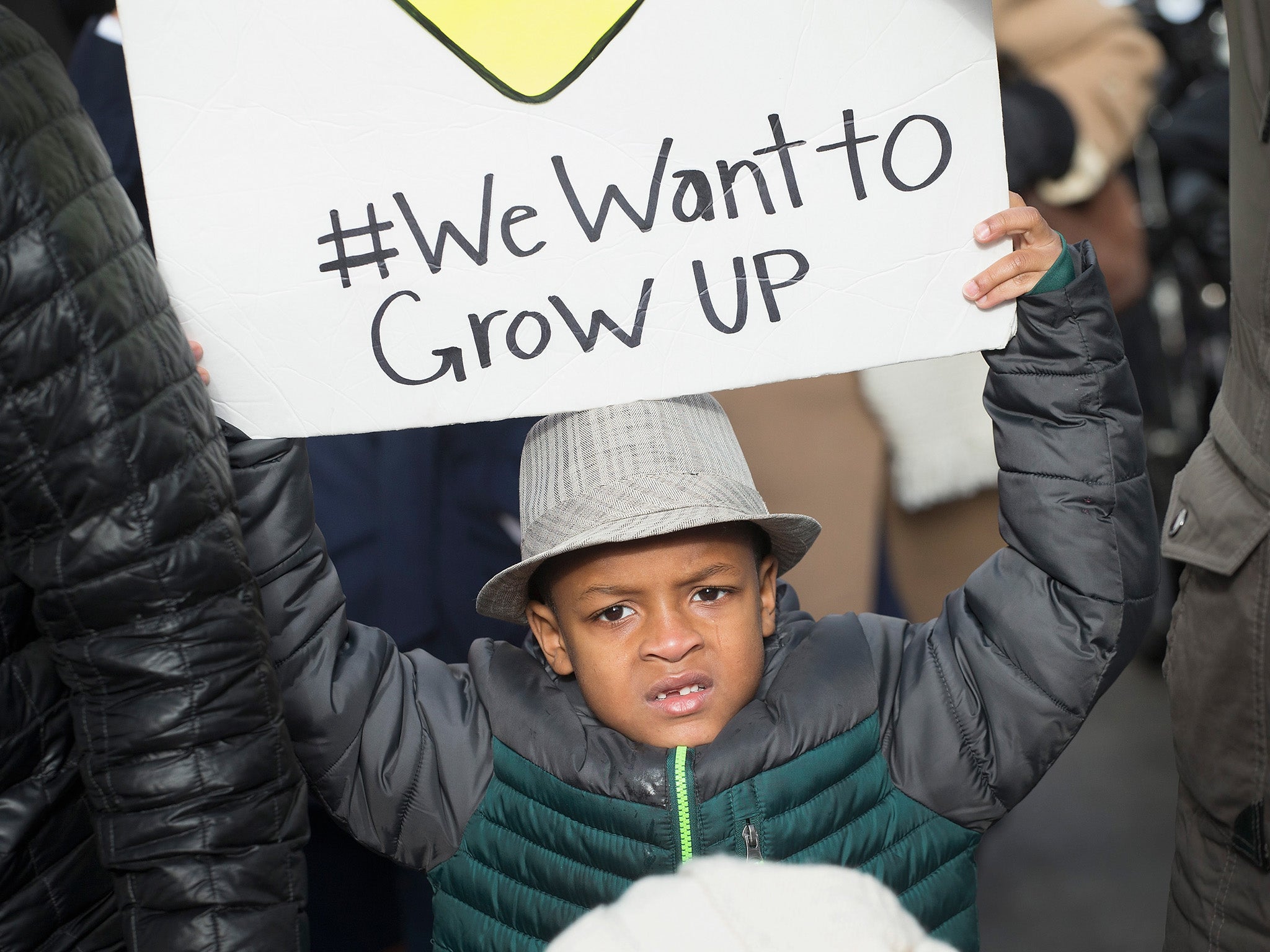 A young boy attends a Chicago gun violence protest in December 2015