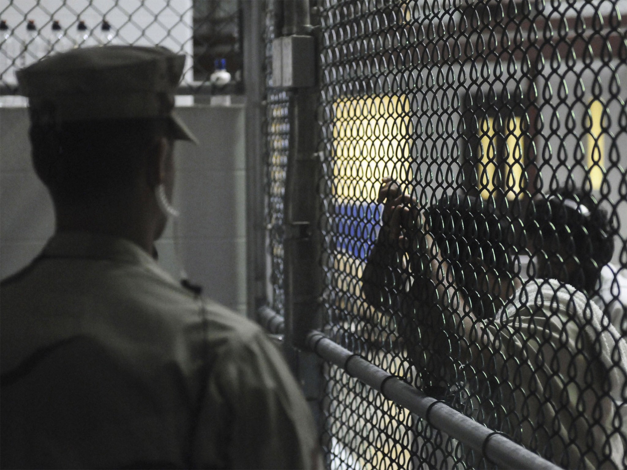 &#13;
A guard watches over detainees in a cell block at Guantanamo Bay &#13;