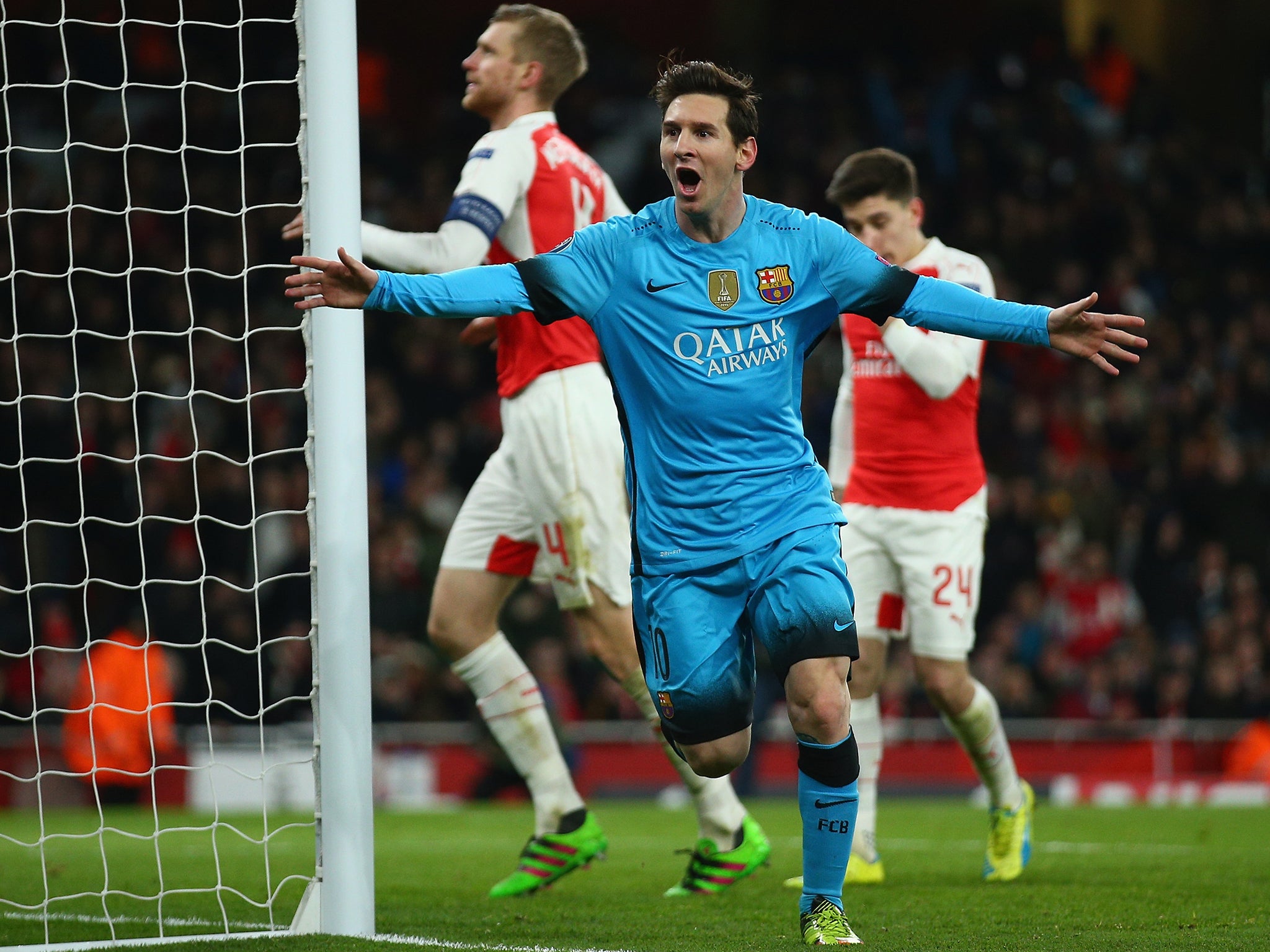 Lionel Messi celebrates his first goal against Arsenal in the first leg at the Emirates