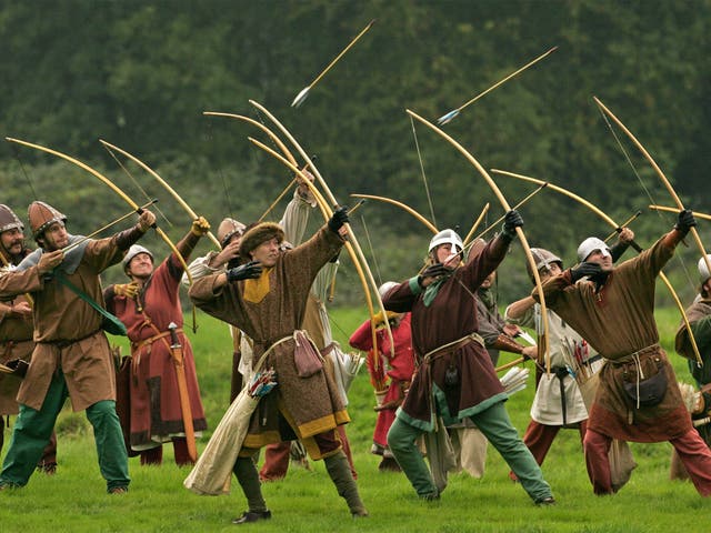Participants dressed as Norman archers take part in a re-enactment of the 1066 Battle of Hastings