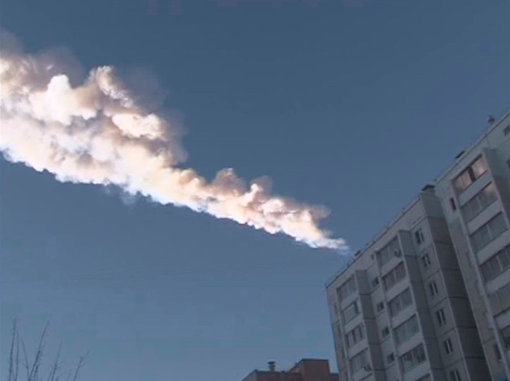 The trail of a falling object is seen above a residential apartment block in the Urals city of Chelyabinsk, in this still image taken from video shot on February 15, 2013