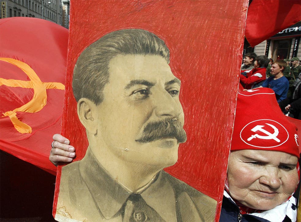 A Russian woman carries a portrait of Soviet leader Josef Stalin in a Victory Day celebration in Moscow