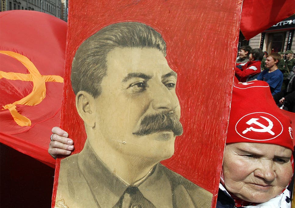 A Russian woman carries a portrait of Soviet leader Josef Stalin in a Victory Day celebration in Moscow