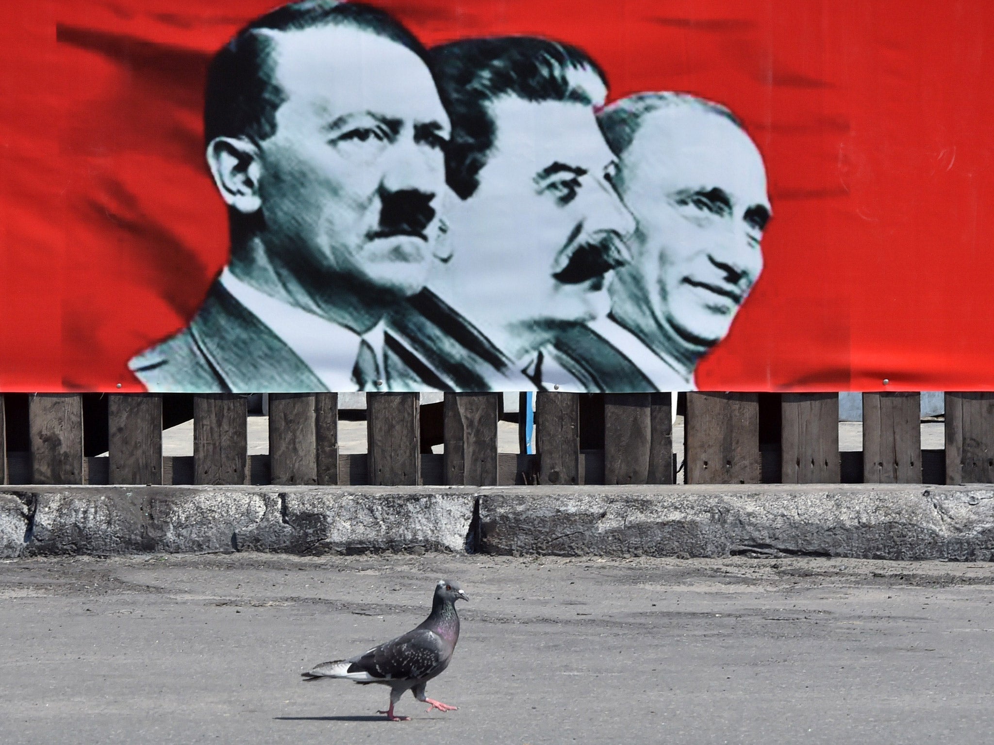A placard depicting Adolf Hitler, Joseph Stalin and Vladimir Putin, in Independence Square, Kiev, in 2014 (Getty)