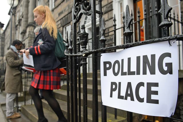 A young voter leaves a polling station after casting her vote