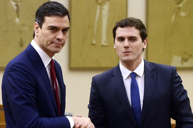 Socialist leader Pedro Sanchez and leader of centre-right party Ciudadanos, Albert Rivera, shake hands after signing an agreement to support Mr Sanchez as candidate to lead the new Spanish government