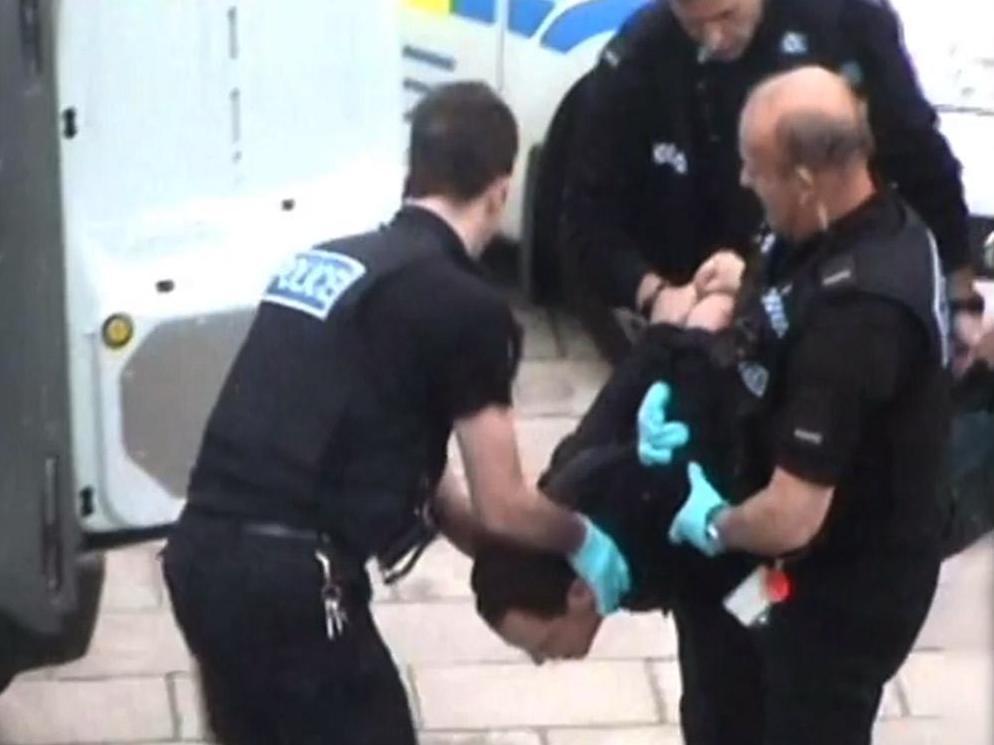 Thomas Orchard being carried into a police van after his arrest in Exeter in 2012