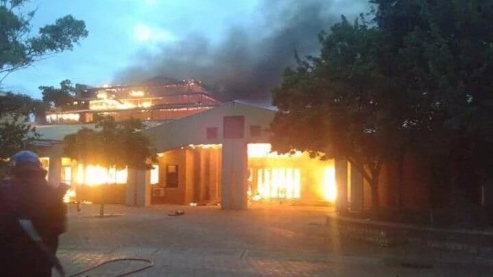 One of the university's buildings burns as the university orders all students to 'return home'