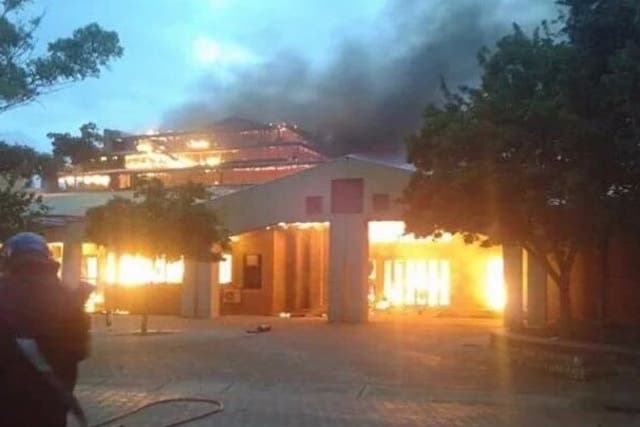 One of the university's buildings burns as the university orders all students to 'return home'