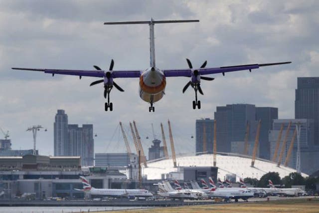 A plane flies in to London City Airport