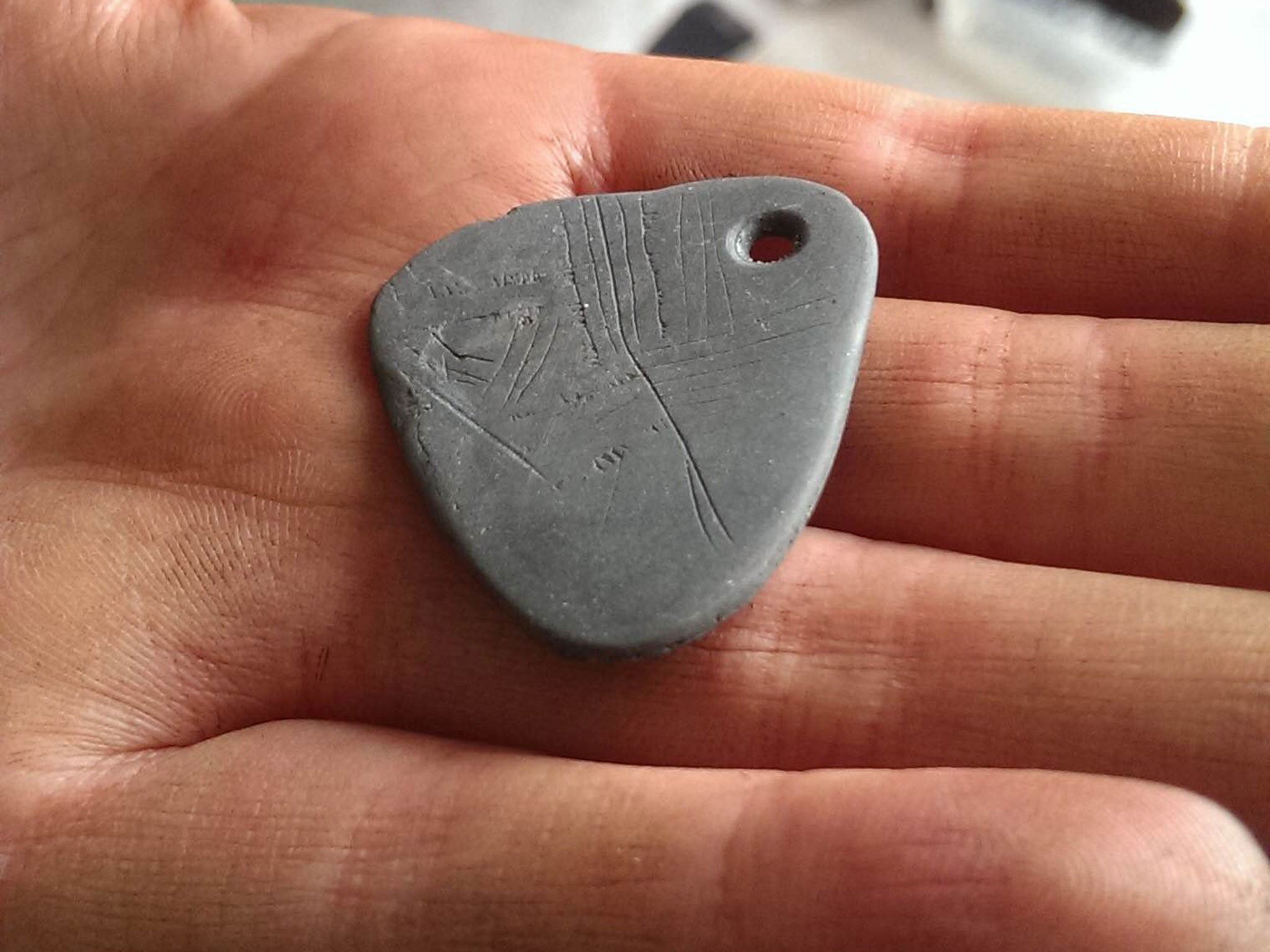 The sacred prehistoric stone pendant, discovered by archaeologists in Yorkshire. It was probably worn by a shaman carrying out hunting-related rituals
