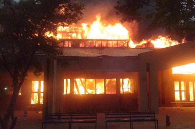 One of the university's buildings burns on Wednesday as management ordered all students to 'leave immediately'