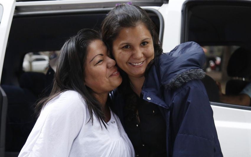 Jacqueline Vasquez Sanchez, left, embraces her sister Lorena Sanchez, right, before a press conference in Bogota, Colombia,