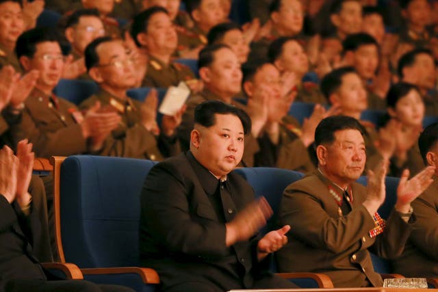 North Korean leader Kim Jong Un (C) applauds during a concert marking the 70th founding anniversary of the Korean People's Army (KPA) military band.