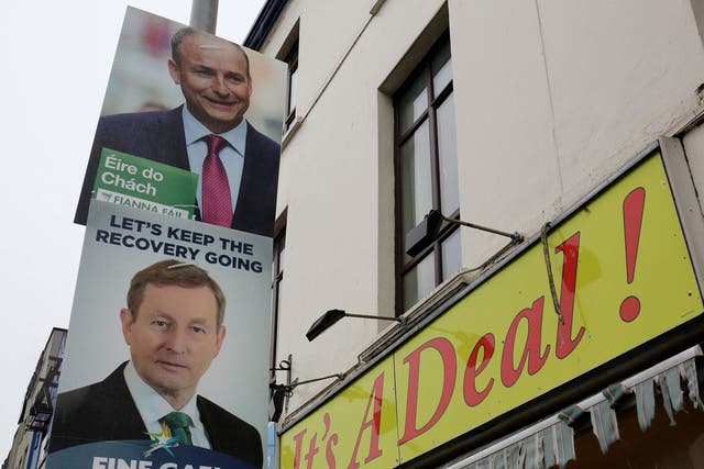 Fianna Fail leader Michael Martin, top, and Fine Gael leader Enda Kenny, on capaign posters in Cork