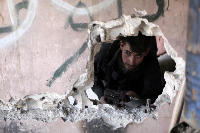 A rebel fighter managing his position in Syria