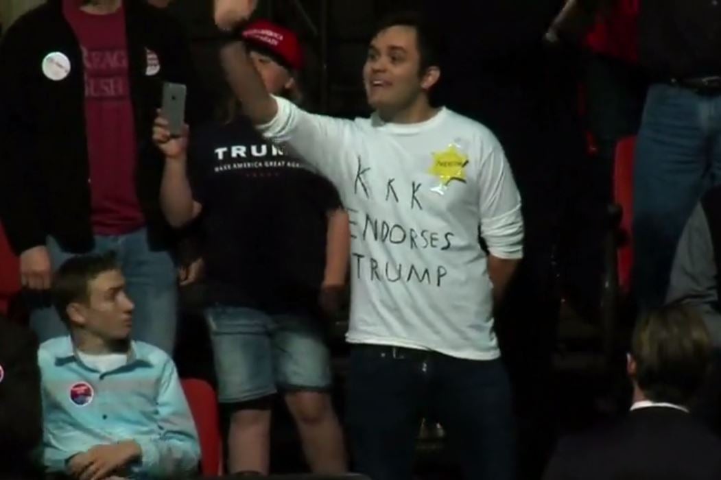 There was booing from the crowd as the man was seen wearing a shirt with the slogan 'KKK endorses Trump' written on it