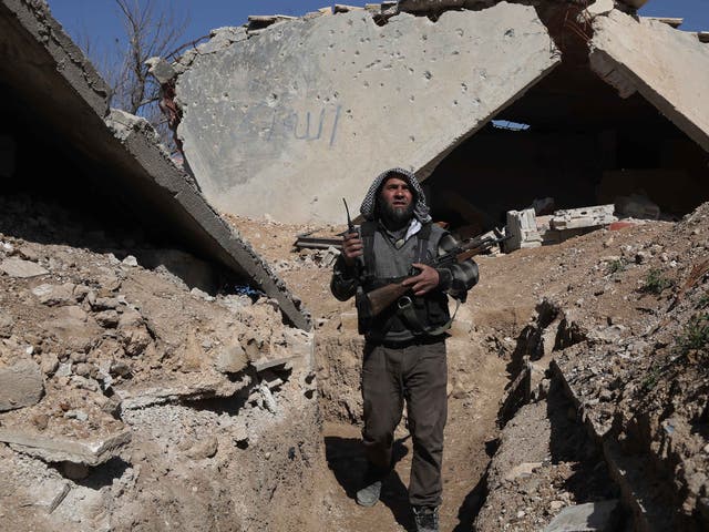 A rebel fighter on guard in the town of Arbin in the eastern Ghouta region near Damascus
