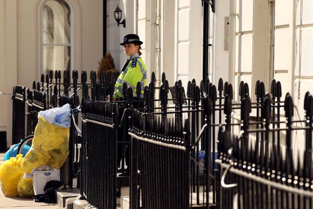 On guard: A PCSO outside a house in London where a body was found